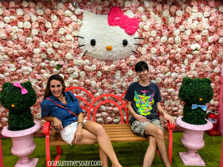 Woman and boy sit on bench at Hello Kitty Island in Seoul